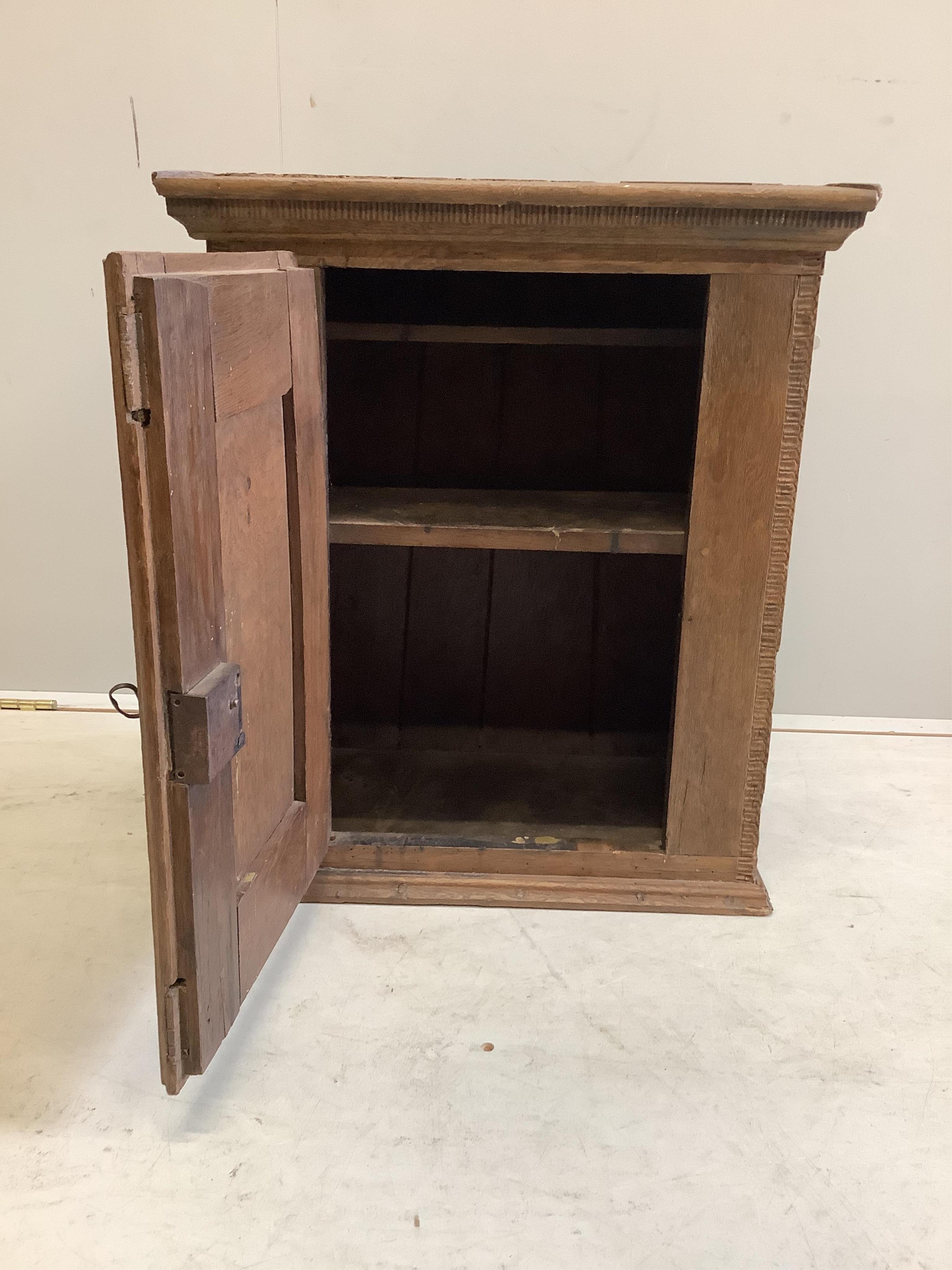 A small oak cupboard, width 51cm, depth 31cm, height 59cm